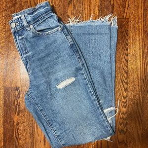 garage denim jeans with cut out knees. high rise with a straight fit.